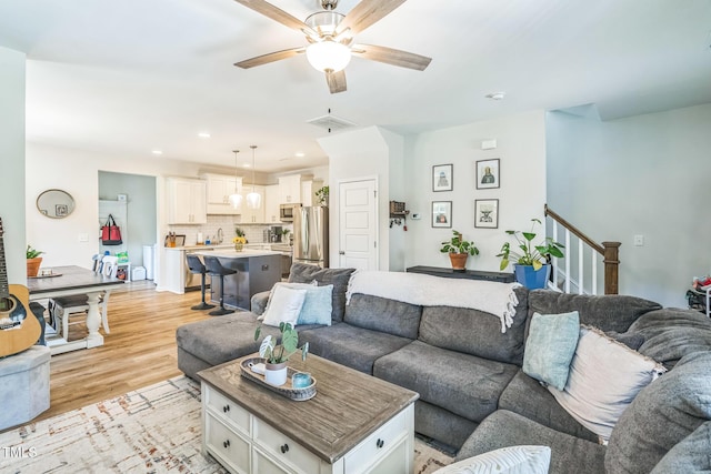 647 N Hardee St, Durham, NC 27703 - living room featuring light wood-style flooring, a ceiling fan, recessed lighting, and stairway