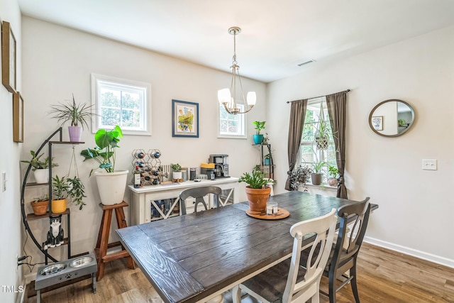647 N Hardee St, Durham, NC 27703 - dining space with wood finished floors, a chandelier, and plenty of natural light