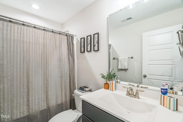 647 N Hardee St, Durham, NC 27703 - full bath featuring vanity, toilet, and recessed lighting
