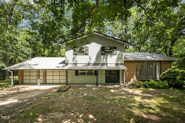 134 Chateau Rd, Durham, NC 27704 - view of front facade with a garage, driveway, and brick siding