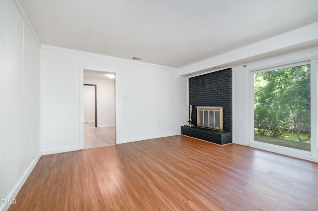 134 Chateau Rd, Durham, NC 27704 - unfurnished living room featuring light wood-type flooring, a fireplace, and baseboards