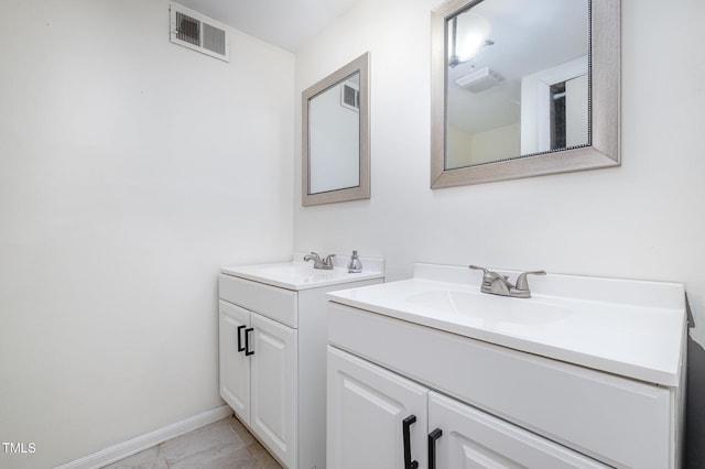 134 Chateau Rd, Durham, NC 27704 - bathroom with two vanities and baseboards