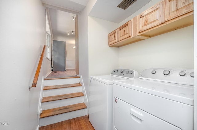 134 Chateau Rd, Durham, NC 27704 - laundry area featuring cabinet space, independent washer and dryer, and light wood-style flooring