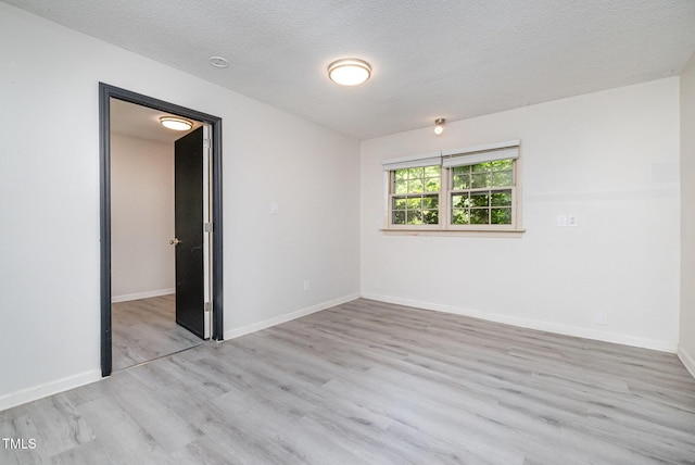 134 Chateau Rd, Durham, NC 27704 - unfurnished room with wood finished floors, baseboards, and a textured ceiling