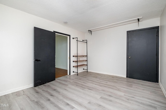 134 Chateau Rd, Durham, NC 27704 - spare room with light wood-style flooring and a textured ceiling