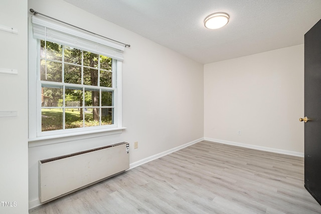 134 Chateau Rd, Durham, NC 27704 - spare room featuring radiator, wood finished floors, and baseboards