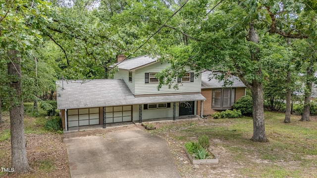134 Chateau Rd, Durham, NC 27704 - view of front facade with a porch, driveway, an attached garage, brick siding, and a chimney
