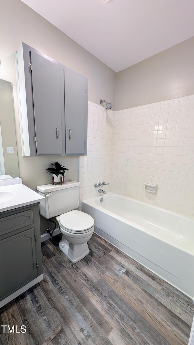 1602 Fairground Rd, Dunn, NC 28334 - bathroom with toilet, wood finished floors, vanity, and bathing tub / shower combination