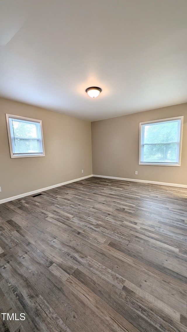 1602 Fairground Rd, Dunn, NC 28334 - spare room featuring plenty of natural light, wood finished floors, and baseboards