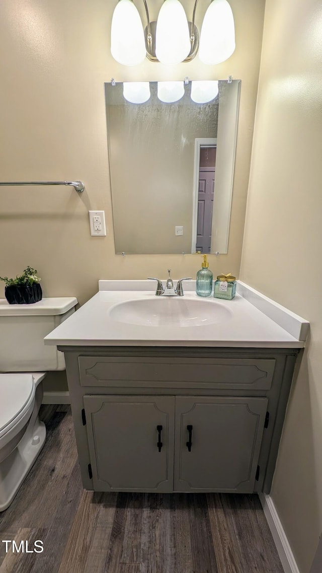 1602 Fairground Rd, Dunn, NC 28334 - half bath with wood finished floors, vanity, and toilet