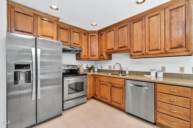 117 Summerlin Dr, Chapel Hill, NC 27514 - kitchen featuring stainless steel appliances, under cabinet range hood, brown cabinets, dark stone counters, and recessed lighting