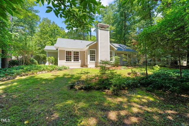 117 Summerlin Dr, Chapel Hill, NC 27514 - back of house with a chimney and a yard