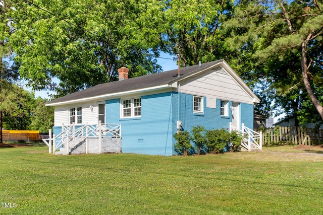 403 S Webb St, Selma, NC 27576 - view of front of home featuring a chimney, brick siding, crawl space, and stairway