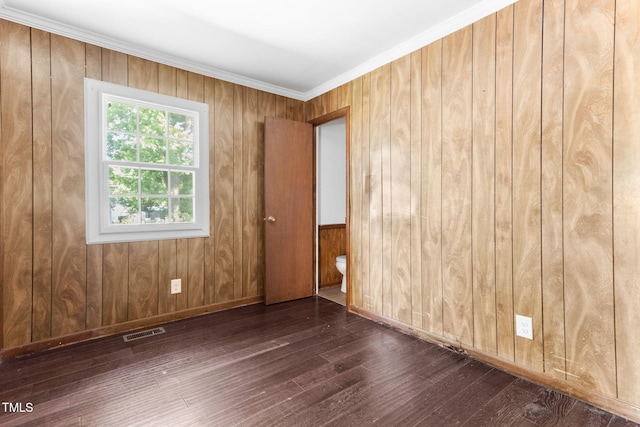403 S Webb St, Selma, NC 27576 - spare room featuring hardwood / wood-style floors, wooden walls, and baseboards