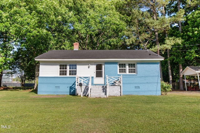 403 S Webb St, Selma, NC 27576 - view of front of home featuring crawl space, brick siding, a front lawn, and a chimney