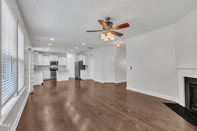 2018 Morehead Hill Ct, Durham, NC 27703 - unfurnished living room with a ceiling fan, dark wood-style flooring, a fireplace, baseboards, and recessed lighting