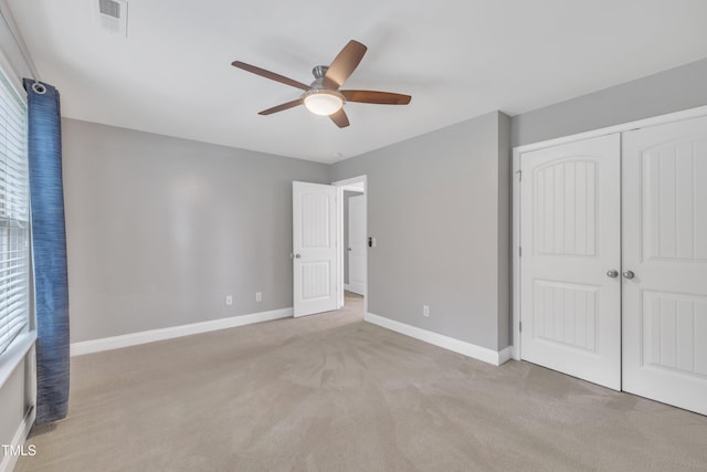 2018 Morehead Hill Ct, Durham, NC 27703 - unfurnished bedroom with light colored carpet, baseboards, a closet, and ceiling fan