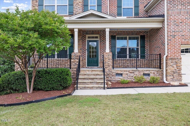 1704 Fawn Chase Ct, Wake Forest, NC 27587 - property entrance with brick siding, covered porch, and a lawn