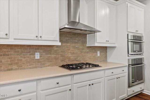 1704 Fawn Chase Ct, Wake Forest, NC 27587 - kitchen featuring wall chimney range hood, appliances with stainless steel finishes, white cabinetry, light countertops, and tasteful backsplash