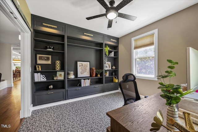 12636 Old Creedmoor Rd, Raleigh, NC 27613 - carpeted home office featuring a ceiling fan, built in shelves, baseboards, and wood finished floors