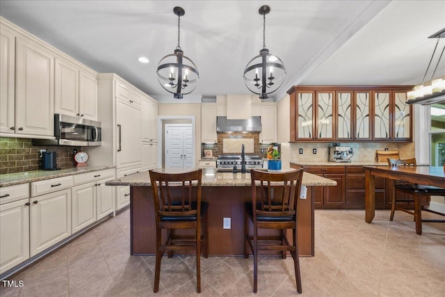 12636 Old Creedmoor Rd, Raleigh, NC 27613 - kitchen with a chandelier, stainless steel appliances, tasteful backsplash, exhaust hood, and recessed lighting