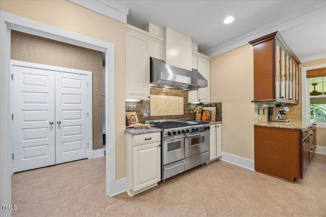 12636 Old Creedmoor Rd, Raleigh, NC 27613 - kitchen featuring double oven range, tasteful backsplash, light tile patterned floors, light stone counters, and crown molding