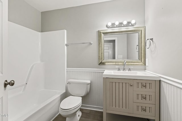 366 E Smithfield St, Angier, NC 27501 - bathroom featuring a wainscoted wall, vanity, toilet, shower / bath combination, and wood finished floors