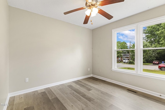 366 E Smithfield St, Angier, NC 27501 - spare room with baseboards, wood finished floors, and a ceiling fan