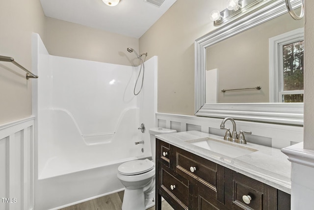 366 E Smithfield St, Angier, NC 27501 - full bathroom featuring vanity, wainscoting, shower / bathtub combination, toilet, and a decorative wall