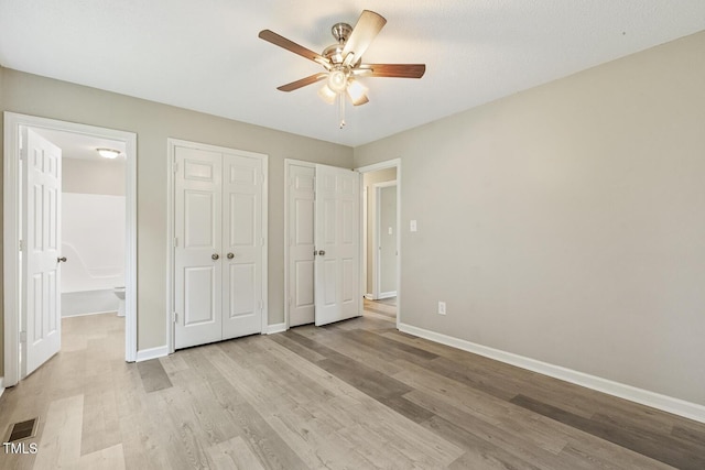 366 E Smithfield St, Angier, NC 27501 - unfurnished bedroom featuring light wood-style floors, baseboards, and a ceiling fan