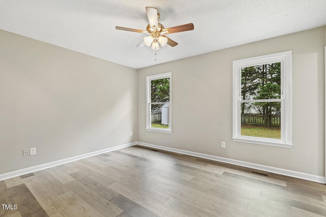 366 E Smithfield St, Angier, NC 27501 - empty room featuring wood finished floors, a ceiling fan, baseboards, and a textured ceiling