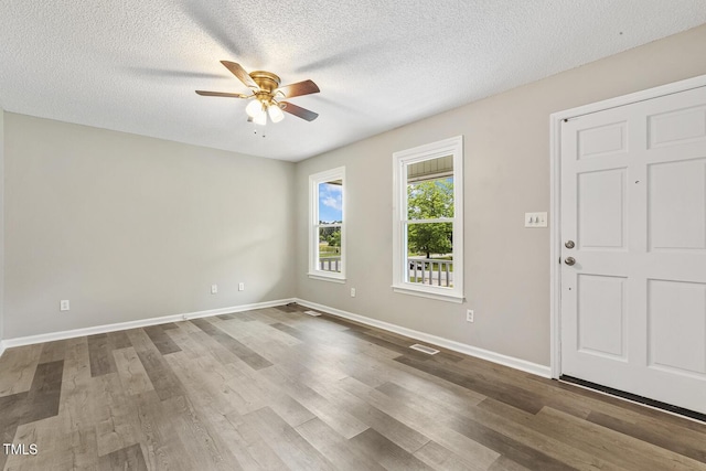 366 E Smithfield St, Angier, NC 27501 - foyer entrance featuring a ceiling fan, wood finished floors, a textured ceiling, and baseboards