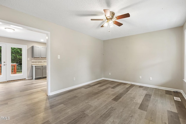 366 E Smithfield St, Angier, NC 27501 - unfurnished room featuring ceiling fan, french doors, light wood-style flooring, and baseboards