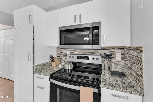 8361 Mcguire Dr, Raleigh, NC 27616 - kitchen featuring appliances with stainless steel finishes, tasteful backsplash, and white cabinets