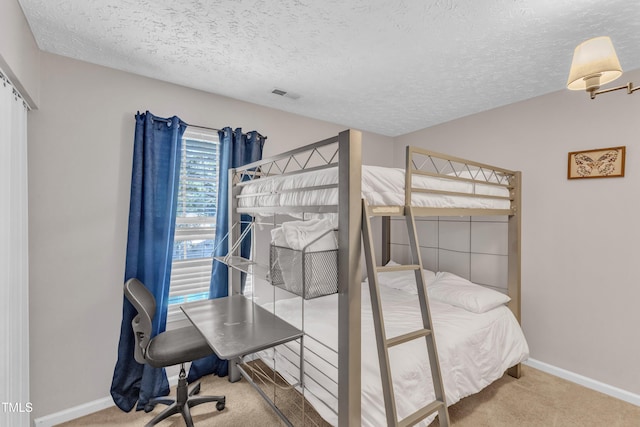8361 Mcguire Dr, Raleigh, NC 27616 - carpeted bedroom with a textured ceiling and baseboards