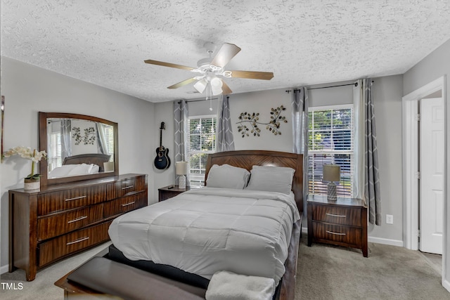 8361 Mcguire Dr, Raleigh, NC 27616 - bedroom featuring light carpet, multiple windows, a textured ceiling, and ceiling fan