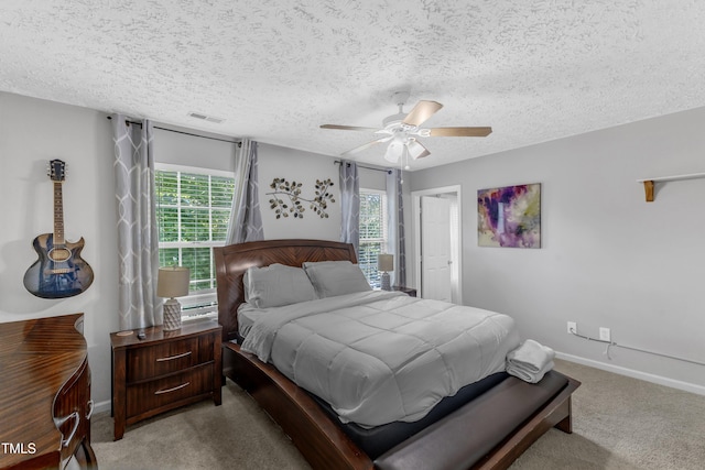 8361 Mcguire Dr, Raleigh, NC 27616 - carpeted bedroom with a ceiling fan and a textured ceiling