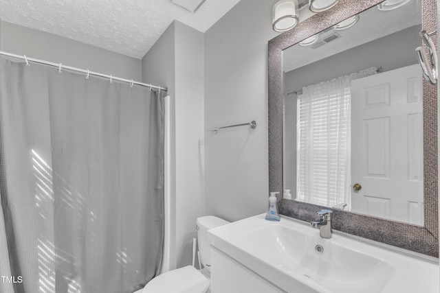 8361 Mcguire Dr, Raleigh, NC 27616 - bathroom with vanity, a textured ceiling, and a shower with shower curtain
