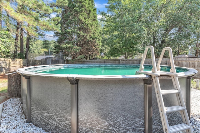 8361 Mcguire Dr, Raleigh, NC 27616 - view of pool featuring a fenced backyard and a trampoline