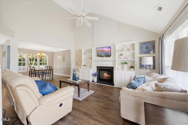 4805 Castle Crest Ct, Raleigh, NC 27616 - living area featuring decorative columns, dark wood-style flooring, high vaulted ceiling, a chandelier, and a fireplace