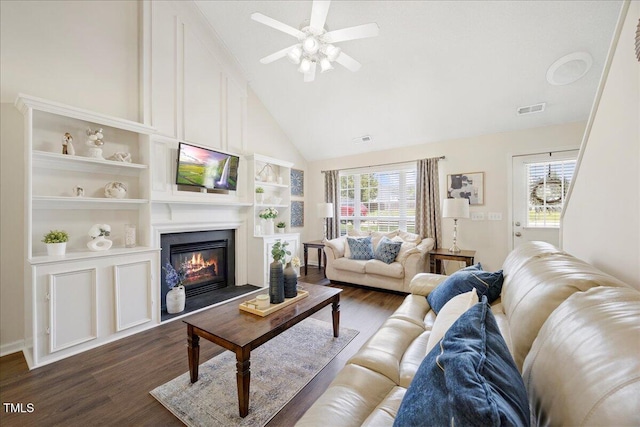 4805 Castle Crest Ct, Raleigh, NC 27616 - living room with dark wood-type flooring, ceiling fan, a fireplace, high vaulted ceiling, and built in features