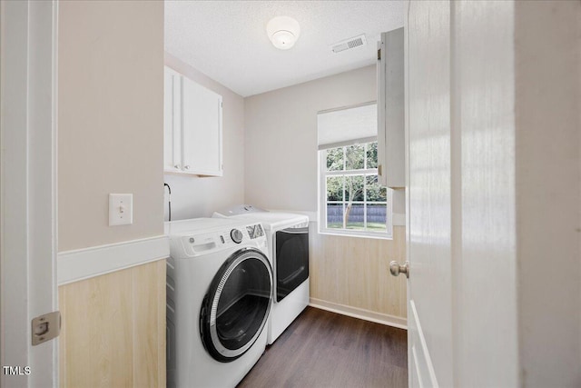 4805 Castle Crest Ct, Raleigh, NC 27616 - washroom with washing machine and dryer, dark wood-style flooring, cabinet space, and baseboards