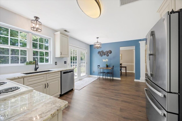 4805 Castle Crest Ct, Raleigh, NC 27616 - kitchen with appliances with stainless steel finishes, a sink, a chandelier, french doors, and dark wood finished floors