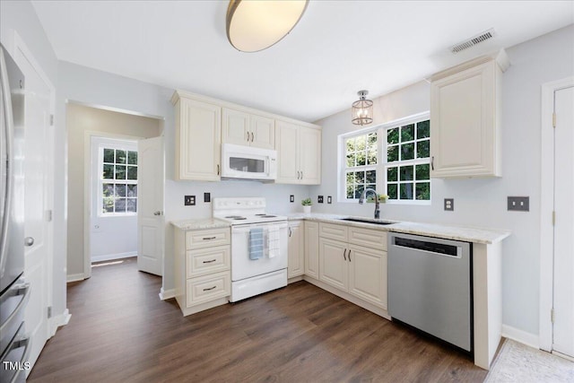 4805 Castle Crest Ct, Raleigh, NC 27616 - kitchen with stainless steel appliances, a sink, dark wood-style flooring, and baseboards