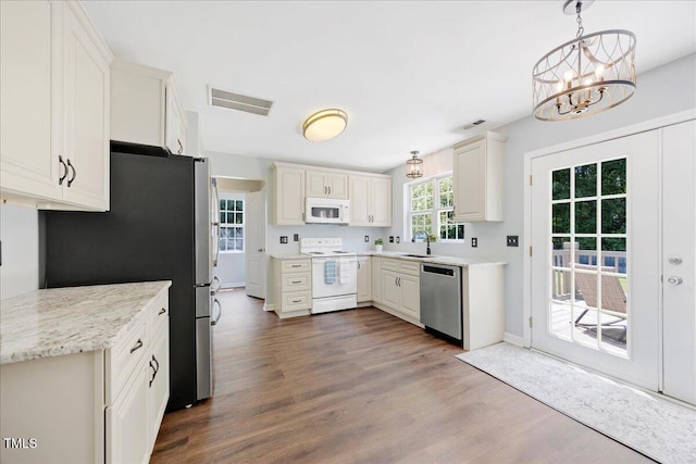 4805 Castle Crest Ct, Raleigh, NC 27616 - kitchen featuring stainless steel appliances, dark wood-type flooring, a chandelier, a sink, and pendant lighting