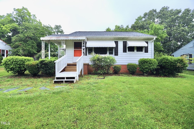 2006 N Ashland Dr, Burlington, NC 27217 - view of front of home with a front lawn, roof with shingles, and covered porch