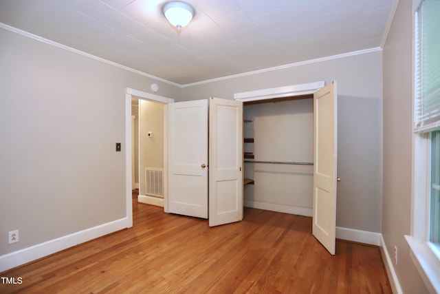 2006 N Ashland Dr, Burlington, NC 27217 - unfurnished bedroom with ornamental molding, light wood-style floors, baseboards, and a closet