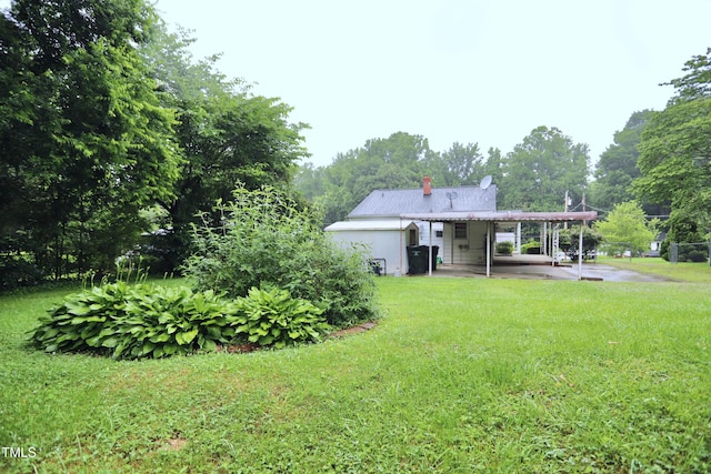 2006 N Ashland Dr, Burlington, NC 27217 - back of house featuring a yard, a chimney, a patio area, and a carport