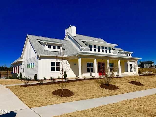 120 Newport Lndg Unit 99, Garner, NC 27529 - view of front facade with a chimney, covered porch, and board and batten siding