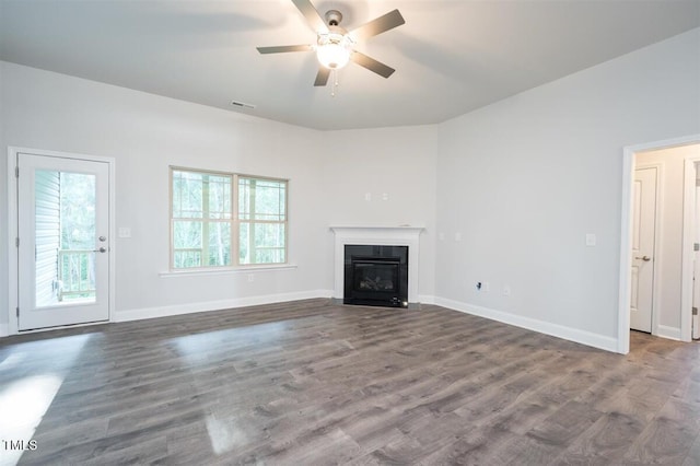 120 Newport Lndg Unit 99, Garner, NC 27529 - unfurnished living room featuring ceiling fan, a fireplace with flush hearth, wood finished floors, and baseboards